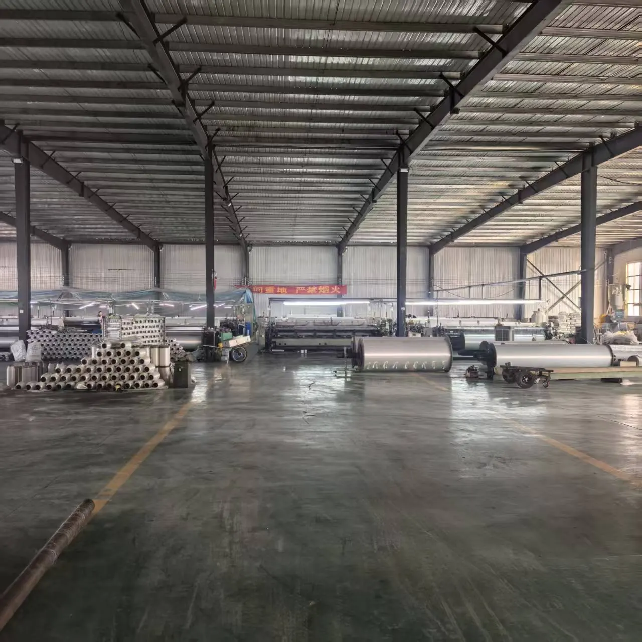 Finished rolls of agricultural netting stored in the production hall